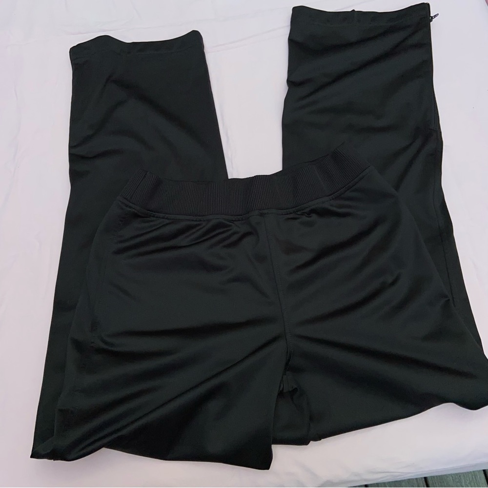 Aasics track pants with zipper hem for ease with sneakers on. Semi-Fitted pants.